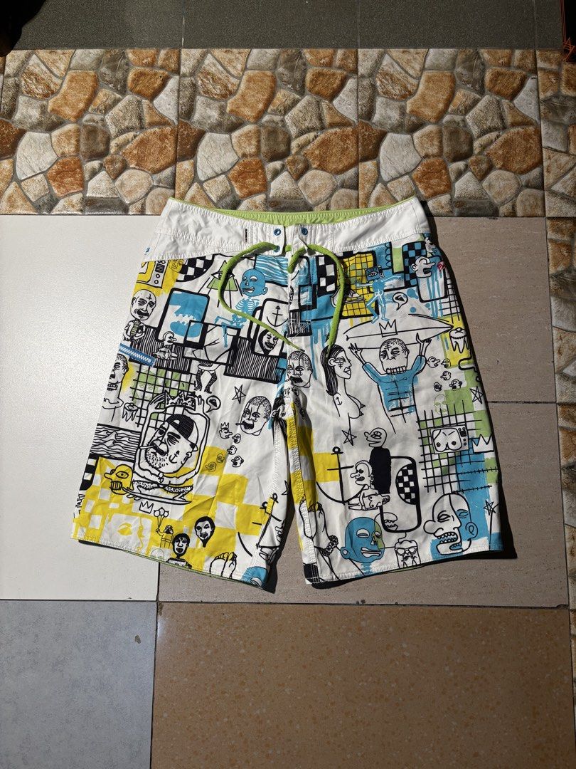 Quiksilver Board Shorts with Graphic Print (Category: Swim Trunks & Board Shorts) located in Paranaque City. Submitted by coveredtags (Listing ID 1435715955, Image 1). Description: - Quiksilver board shorts - Unique colorful graphic print - White base with various figures and patterns - Drawstring closure - White waistband with green accents - Lightweight material - Ideal for water activities.