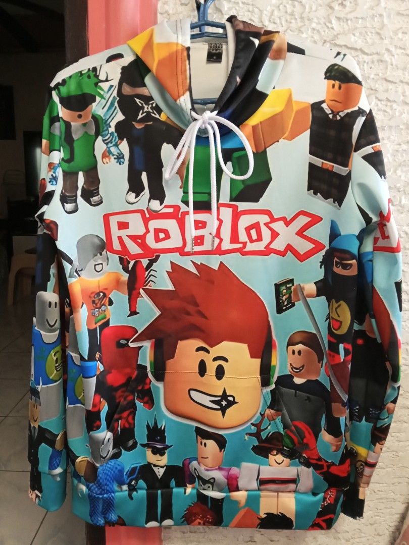 Roblox Hoodie (Category: Coats, Jackets and Outerwear) located in Cavite. Submitted by ronessabrandedshoes2ndaccount (Listing ID 1435759294, Image 1). Description: - Roblox design hoodie - Full-zip closure - Hood with drawstrings - Features Roblox characters and logo - Measurements: 16 inches (chest), 20 inches (length).