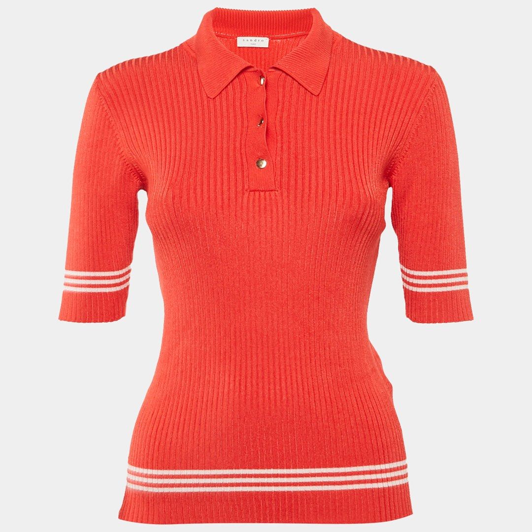 SANDRO PARIS - Red Ribbed Polo Shirt (Category: Shirts) located in Cavite. Submitted by gooditems.cavite (Listing ID 1435905641, Image 2). Description: Fits small to large womens Stretchable fabric 15x22 dimensions - Sandro red polo shirt - Ribbed texture - Classic polo collar - Short sleeves with white stripes - Three-button placket - White stripes on bottom hem - Sandro brand label visible - Made in Hong Kong.