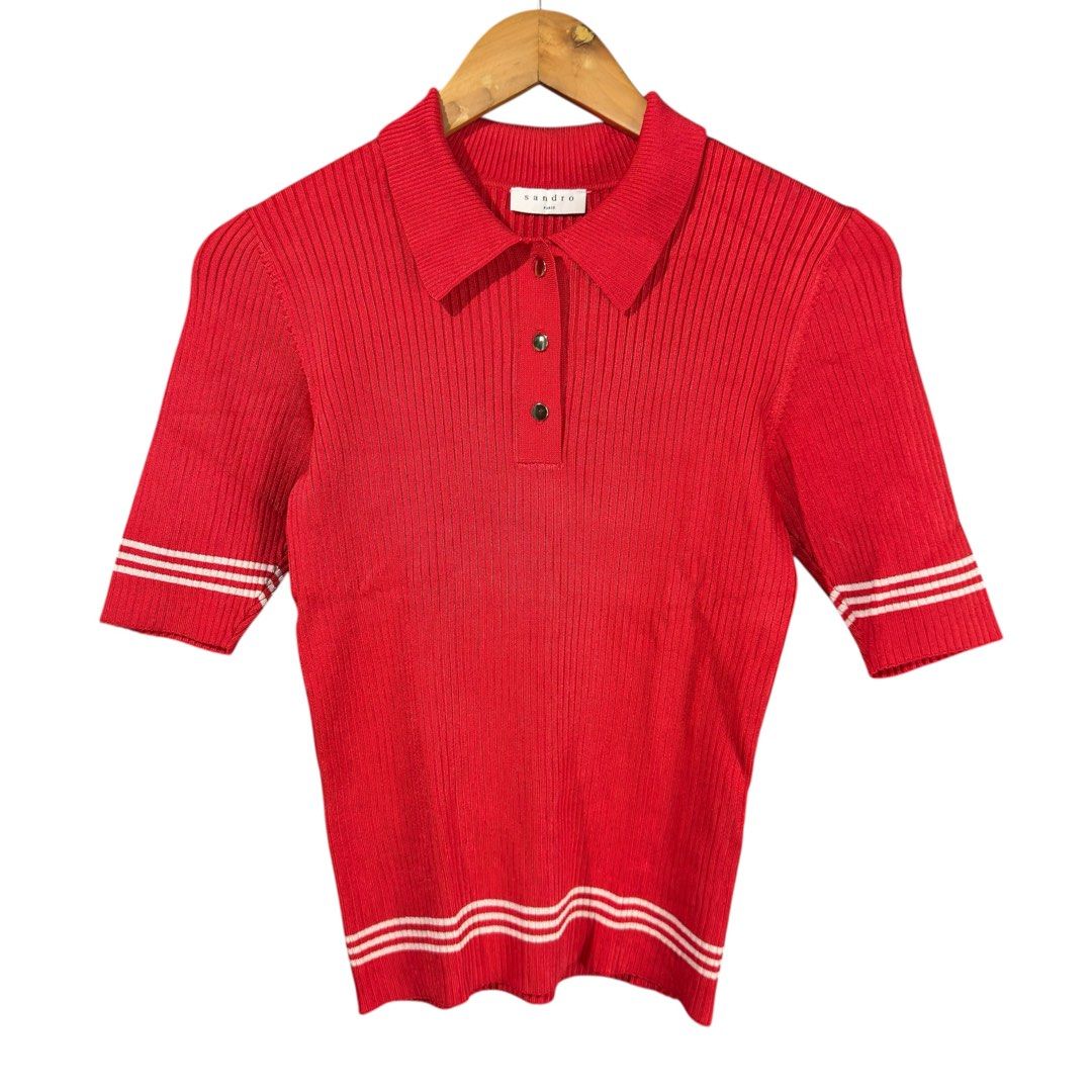 SANDRO PARIS - Red Ribbed Polo Shirt (Category: Shirts) located in Cavite. Submitted by gooditems.cavite (Listing ID 1435905641, Image 1). Description: Fits small to large womens Stretchable fabric 15x22 dimensions - Sandro red polo shirt - Ribbed texture - Classic polo collar - Short sleeves with white stripes - Three-button placket - White stripes on bottom hem - Sandro brand label visible - Made in Hong Kong.