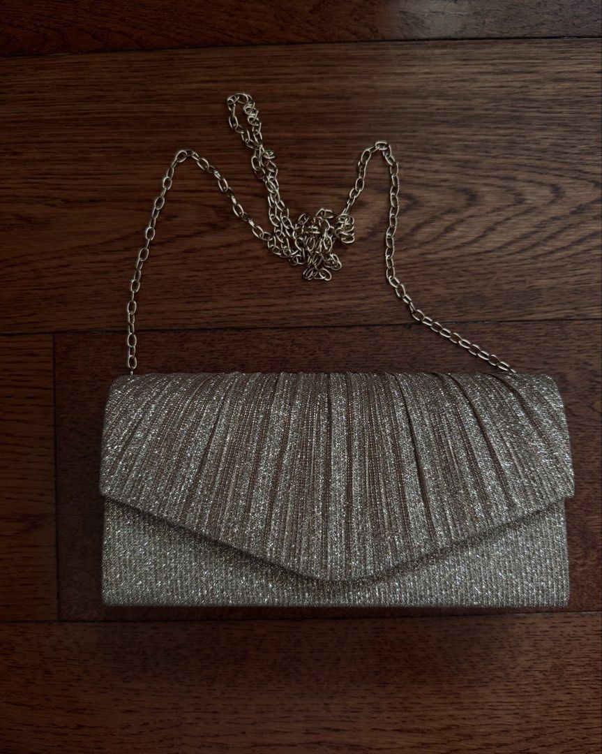 Shein Gold Pleated Clutch with Chain Strap (Category: Clutches) located in San Juan City. Submitted by yannaaabanana (Listing ID 1435788049, Image 1). Description: - Gold pleated clutch bag - Detachable chain strap - Light pink interior - Magnetic snap closure - Perfect for special occasions.