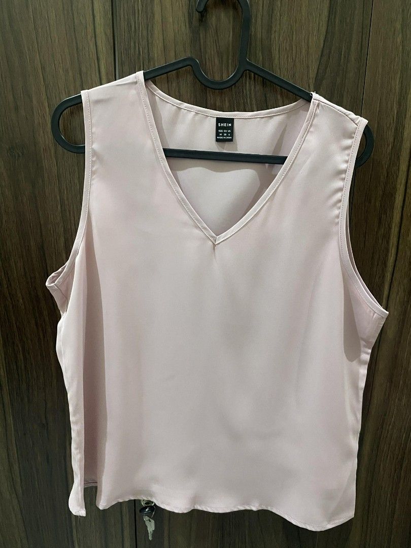 Shein Office V-neck Sleeveless Top (Category: Sleeveless) located in Manila. Submitted by heyzehl (Listing ID 1435892426, Image 1). Description: - Shein V-neck top - Sleeveless design - Light pink color - Size: M (EU 38, US 6) - Made from smooth fabric - Versatile and easy to pair.