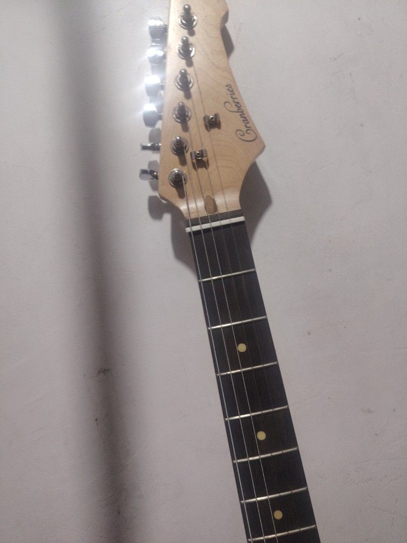 SQOE guitar (Fender squier like) (Category: Musical Instruments) located in Caloocan City. Submitted by beatfinds (Listing ID 1435797918, Image 2). Description: - Light grey body with white pickguard - Three single-coil pickups - Stratocaster - Squire like - Tremolo system - Dot inlays - Includes whammy bar.