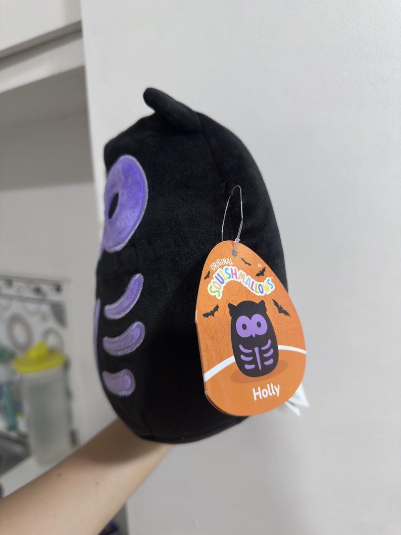 Squishmallows Holly the Owl (Category: Plushies & Soft Toys) located in Rizal. Submitted by GirlDeclutter (Listing ID 1435822302, Image 3). Description: - Squishmallows Holly the Owl plush toy - Features a black body with purple accents - Includes a unique skeleton design - Comes with the original tag - Soft and cuddly material - Perfect for collectors or gifting.