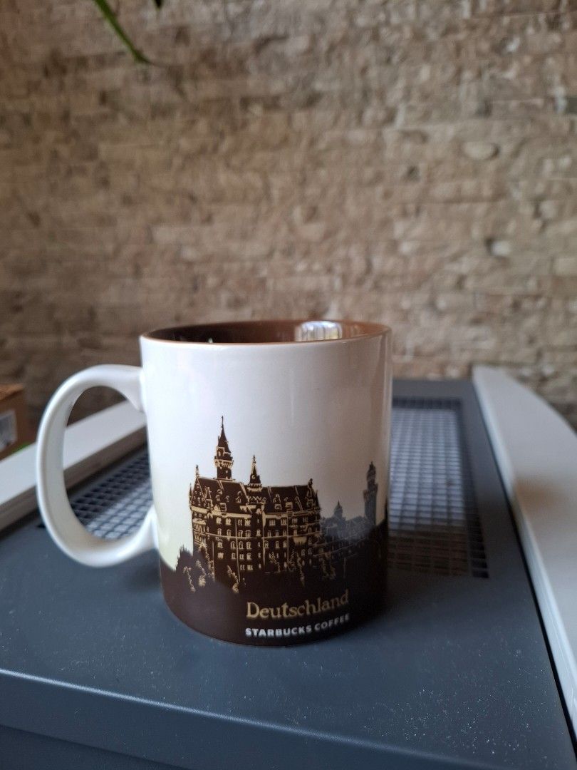 Starbucks Germany Mug (Category: Coffee & Tea Tableware) located in Makati City. Submitted by itemsforless2025 (Listing ID 1435772159, Image 2). Description: - Starbucks Germany mug - Features a white exterior design with a cityscape and the word "Germany" - Brown interior - Made of ceramic - Includes a handle - Features the Starbucks logo -no box #carousave2026.