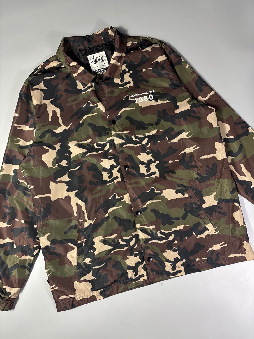 Stussy 1980 Coach Camou Jacket (Category: Coats, Jackets and Outerwear) located in Manila. Submitted by whowearsstreetwear (Listing ID 1435893636, Image 3). Description: Stussy World Wide 1980 Coach Camou Jacket - Size: Large on tag fits XL (measurements in inches) W - 26 L - 31 Condition: Very Good Flaw/s: minor hairlines + shipping fee Location: Manila (Near UST).