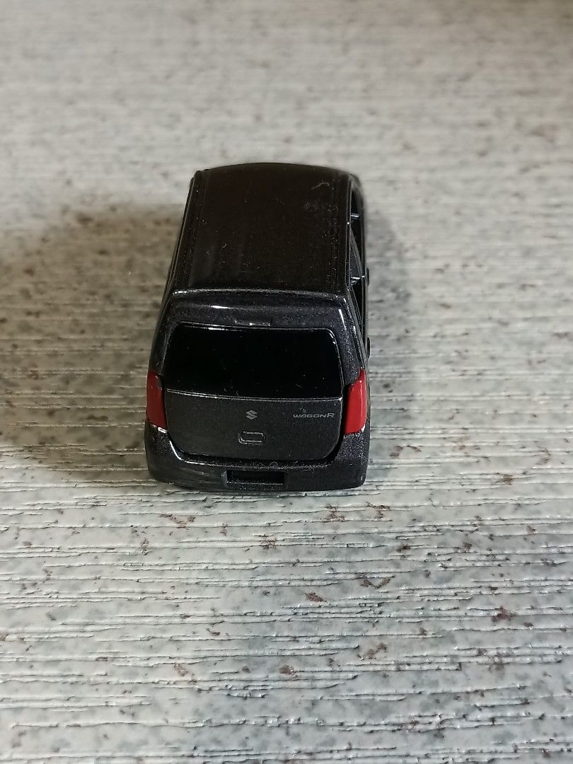 Suzuki Wagon R Toy Car (Category: Vehicle & Diecast Models) located in Quezon City. Submitted by Bernz (Listing ID 1435766778, Image 2). Description: - Detailed Suzuki Wagon R toy car. - Features a detailed front grill and headlights. - Includes rear tail lights. - Trunk can be opened. - Has four wheels. - Likely made of diecast metal or plastic. - Miniature replica of the real Suzuki Wagon R..
