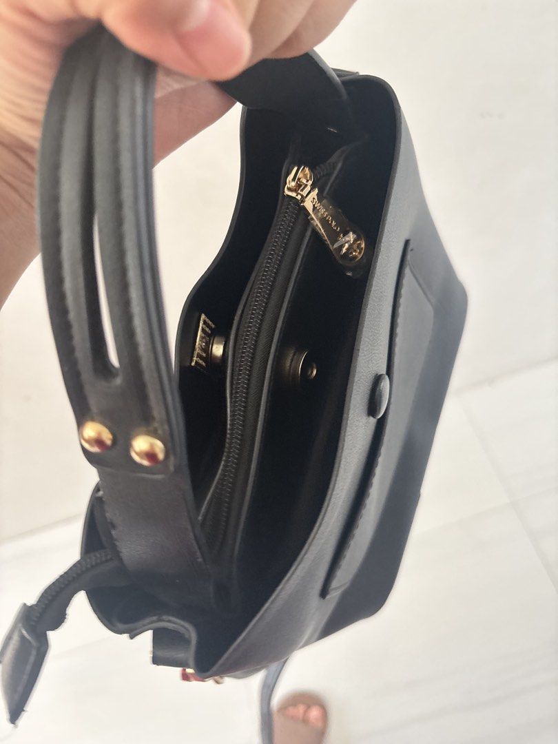 Swiss Polo Black Bucket Bag (Category: Shoulder Bags) located in Bulacan. Submitted by mreyes21 (Listing ID 1435775493, Image 3). Description: - Swiss Polo black bucket bag - Top handle and detachable shoulder strap - Gold-toned chain detail and hardware - Zippered main compartment - Exterior pocket - Interior small zippered pocket - Magnetic snap closure.