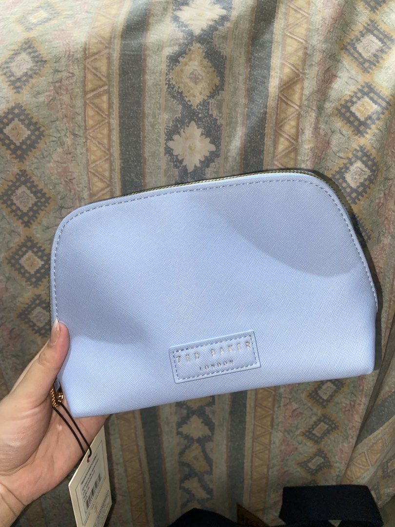 Ted Baker London Cosmetic Bag (Category: Luxury Bags & Wallets) located in San Pedro. Submitted by bellyellie9 (Listing ID 1435824882, Image 1). Description: - Ted Baker London cosmetic bag - Light blue color - Floral interior - Gold zipper - Includes two small travel bottles - Comes with silica gel packets.
