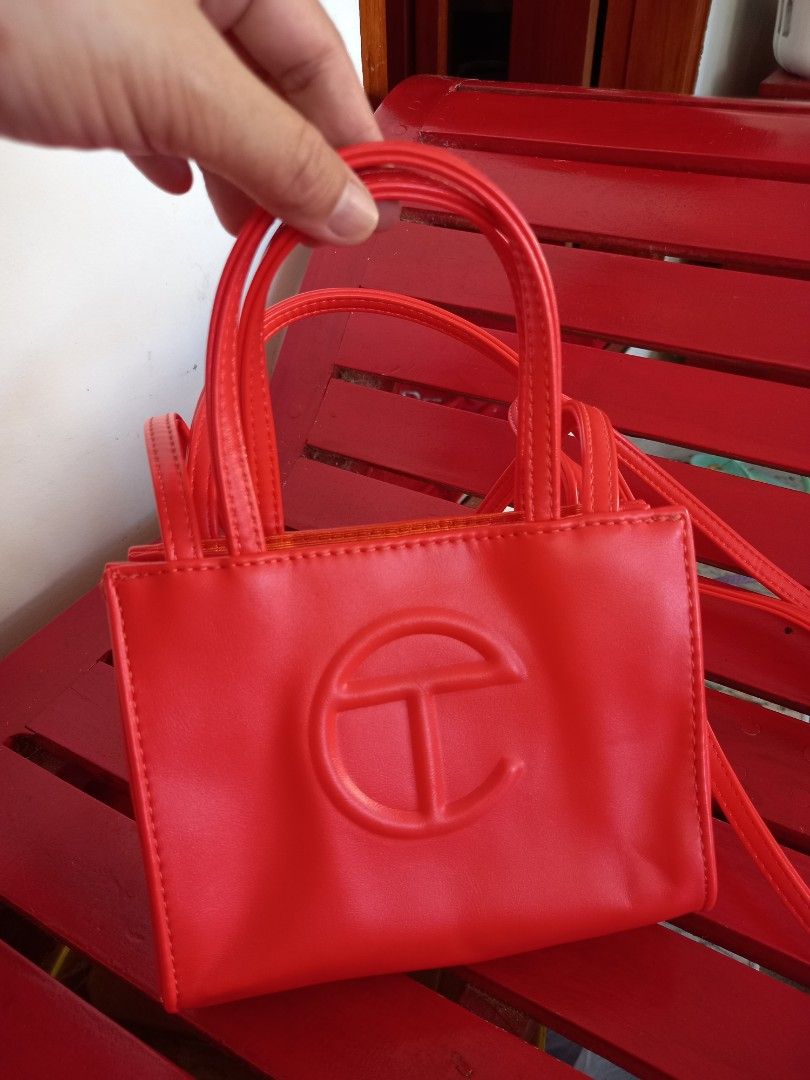 Telfar Shopping Bag Small Red orange (Category: Luxury Bags & Wallets) located in Tuguegarao City. Submitted by zenphoenix-7ad615 (Listing ID 1435791765, Image 3). Description: - Telfar Shopping Bag in Red orange - Structured design - Features a top handle and shoulder strap - Telfar logo embossed on the front - Interior lined with orange fabric - Snap closure.
