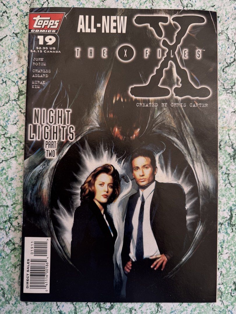 The X-Files Comic Book #19 (Category: Comics & Manga) located in San Juan City. Submitted by redgecollection (Listing ID 1435769180, Image 1). Description: For UFO and X-Files Collectors: - The X-Files comic book issue #19. - Features "Night Lights Part Two." - Published by Topps Comics. - Created by Chris Carter. - Features Mulder and Scully on the cover. - In English..