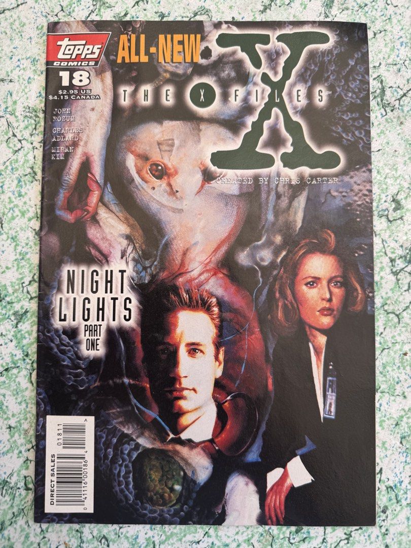 The X-Files Comics #18 (Category: Comics & Manga) located in San Juan City. Submitted by redgecollection (Listing ID 1435769630, Image 1). Description: For UFO and X-Files Collectors: Issue #18 of The X-Files comic book series, titled "Night Lights Part One." Published by Topps Comics. Features artwork of Mulder and Scully. Created by Chris Carter. Published in June 1996. Includes the names of the writers, artists, and other contributors..