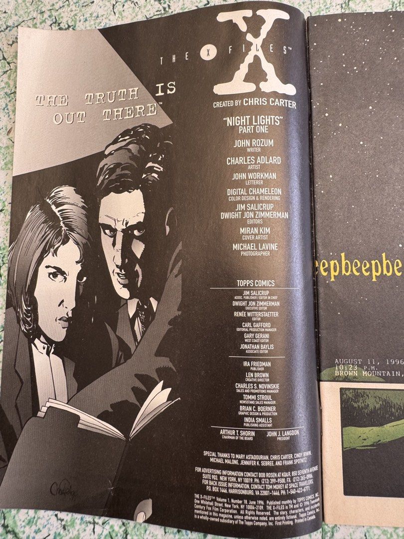 The X-Files Comics #18 (Category: Comics & Manga) located in San Juan City. Submitted by redgecollection (Listing ID 1435769630, Image 2). Description: For UFO and X-Files Collectors: Issue #18 of The X-Files comic book series, titled "Night Lights Part One." Published by Topps Comics. Features artwork of Mulder and Scully. Created by Chris Carter. Published in June 1996. Includes the names of the writers, artists, and other contributors..
