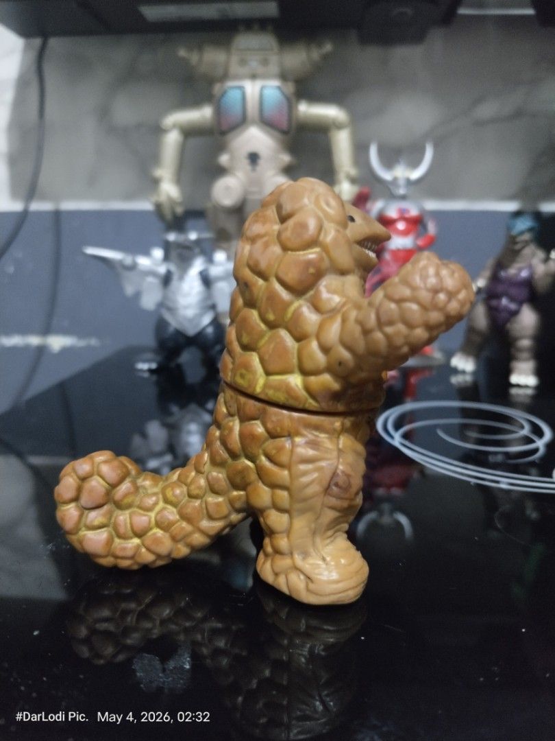 Ultraman Kaiju Monster Figure unmarked. (Category: Figurines & Statues) located in Pasay City. Submitted by mancave07 (Listing ID 1435901057, Image 3). Description: - Vintage Ultraman monster figure - Features a brown, textured body - Detailed face and raised arms - Unique segmented body and tail design - Perfect for Ultraman fans and collectors.