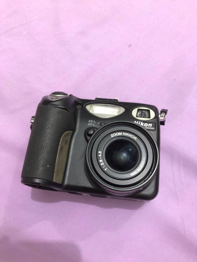 UNTESTED!!! Nikon Coolpix 5000 Digital Camera (Category: Cameras) located in Manila. Submitted by mochii1221 (Listing ID 1435903749, Image 1). Description: - Nikon Coolpix 5000 digital camera - Features a Zoom Nikkor lens - Built-in flash - Flip-out LCD screen - SD card slot - Battery cover is missing but you can tie it with ponytail if you had the battery - uses nikon EN-EL1 battery buy at your own risk no refund, no replace, return.
