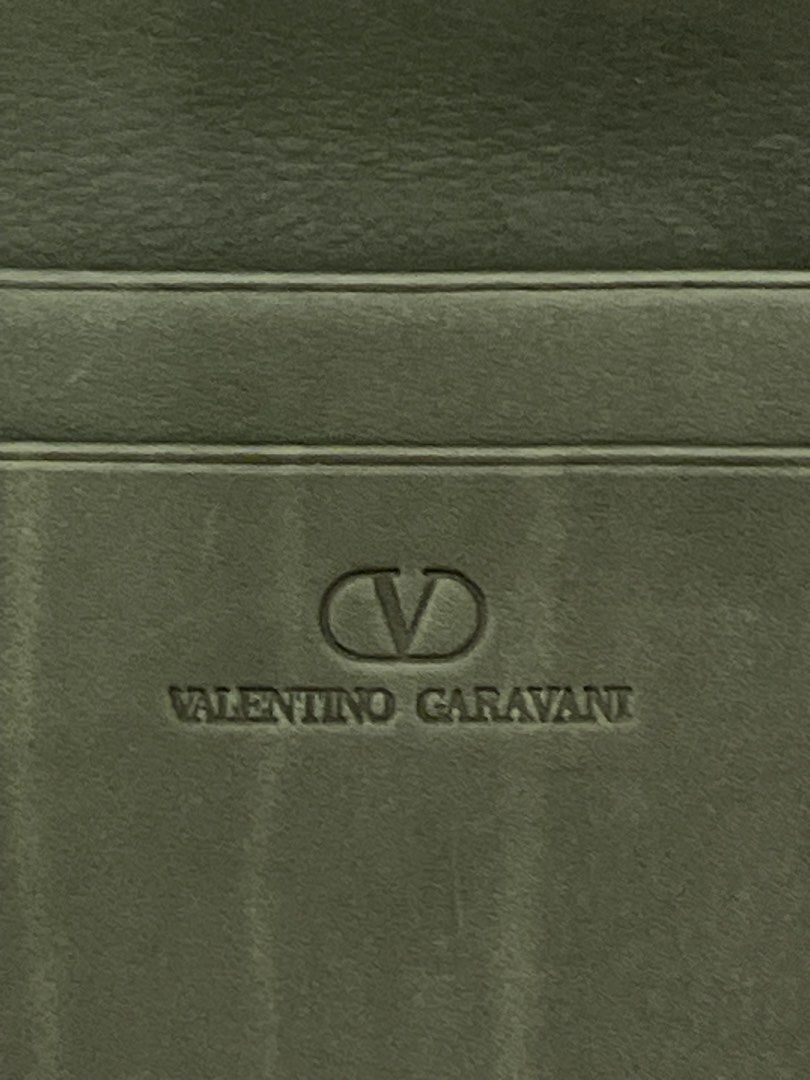 Valentino Garavani Long Wallet (Category: Luxury Bags & Wallets) located in Marilao. Submitted by wardrovearchives (Listing ID 1435910880, Image 1). Description: - Valentino Garavani long wallet - Green leather exterior -Almost new, Soft leather - Features the Valentino Garavani logo - Interior with multiple card slots - Includes a zippered compartment - Zipper pull engraved with the brand name - Includes a T. Ishii (Most likely pernal stamp).