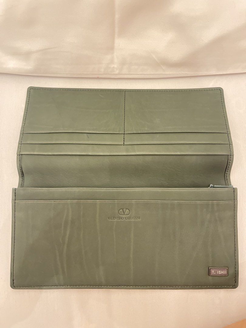 Valentino Garavani Long Wallet (Category: Luxury Bags & Wallets) located in Marilao. Submitted by wardrovearchives (Listing ID 1435910880, Image 3). Description: - Valentino Garavani long wallet - Green leather exterior -Almost new, Soft leather - Features the Valentino Garavani logo - Interior with multiple card slots - Includes a zippered compartment - Zipper pull engraved with the brand name - Includes a T. Ishii (Most likely pernal stamp).