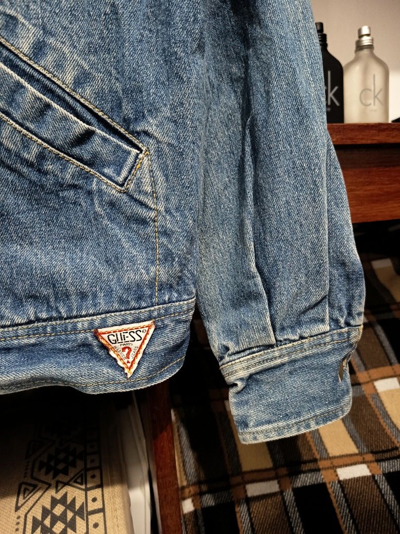 Vintage Guess Denim Trucker Logo Jacket (Category: Coats, Jackets and Outerwear) located in Dagupan City. Submitted by plugofallthreads (Listing ID 1435901714, Image 2). Description: Vintage Guess Denim Trucker Logo Jacket Made in USA Size: Men's Small Length: 25 inches Width: 22 inches Sleeve Length: 29 inches Price: Php 1,500 plus sf DM TO PURCHASE.