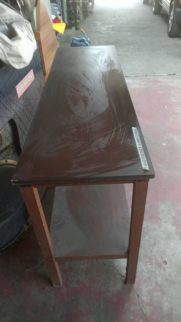 Wooden Console Table (Category: Tables & Sets) located in Quezon City. Submitted by madelrivera (Listing ID 1435852063, Image 1). Description: - Wooden console table - Dark brown tabletop - Lower shelf for storageLARGE WOODEN TABLE WORKBENCH 150CM HABA 45CM LAPAD 80CM TAAS FOR SALE 1800 LOCATION CARLOS EXTENSION SAN BARTOLOME NOVA QC - Rectangular shape - Simple design - Suitable for display or console use.