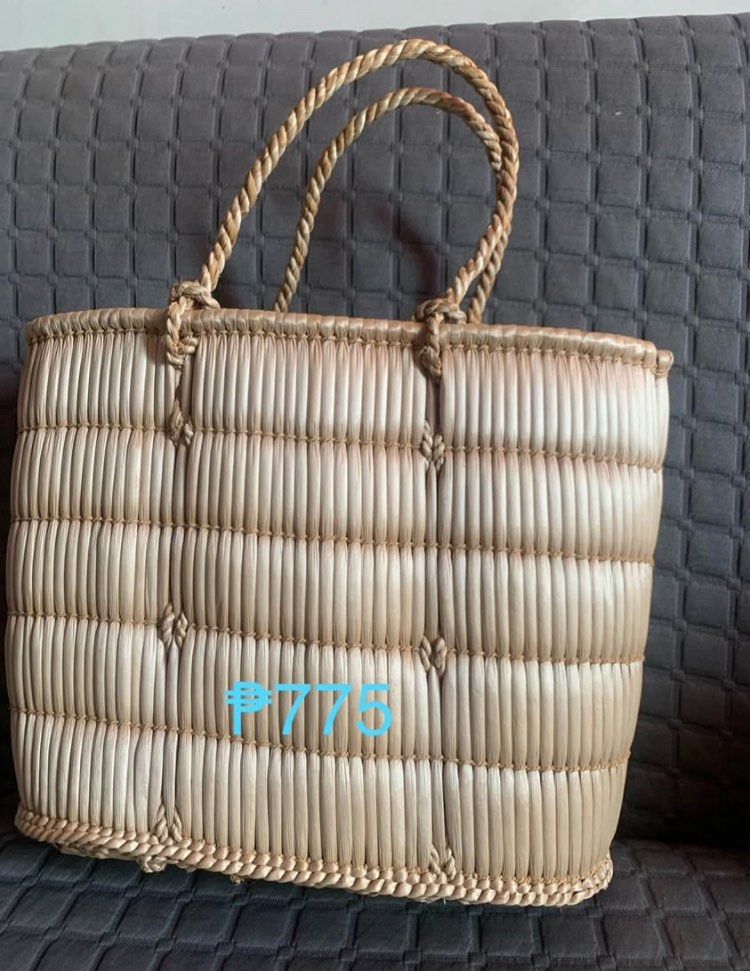 Woven Basket Bag (Category: Tote Bags) located in Makati City. Submitted by BRANDEDJAPANGOODS (Listing ID 1435749589, Image 3). Description: Handwoven basket bag with sturdy handles. Features a natural, light brown color. The bag has a rectangular shape with a woven design. The bag's dimensions are approximately 30cm in length and 20cm in height..