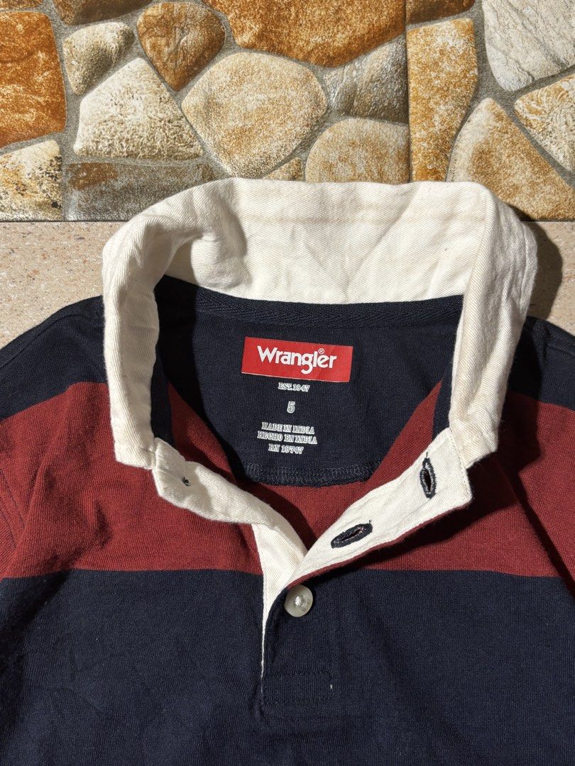 Wrangler Striped Rugby Shirt (Category: Tshirts & Polo Shirts ) located in Paranaque City. Submitted by coveredtags (Listing ID 1435715760, Image 3). Description: - Wrangler rugby shirt - Size: S - Color: Navy and maroon stripes - Features a white collar and button-up placket - Made in India - Material: Cotton and polyester blend - Style: Long-sleeved, casual wear.