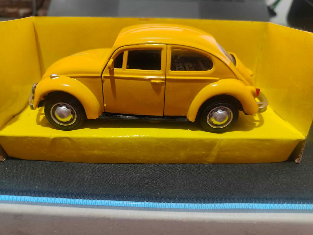 Yellow Volkswagen Beetle Toy Car (Category: Vehicle & Diecast Models) located in Manila. Submitted by cooldude0613 (Listing ID 1435714792, Image 2). Description: - Yellow Volkswagen Beetle toy car - Brand new, in original packaging - Features detailed wheels and windows - Miniature replica of the classic Beetle design - Displayed on a yellow base.