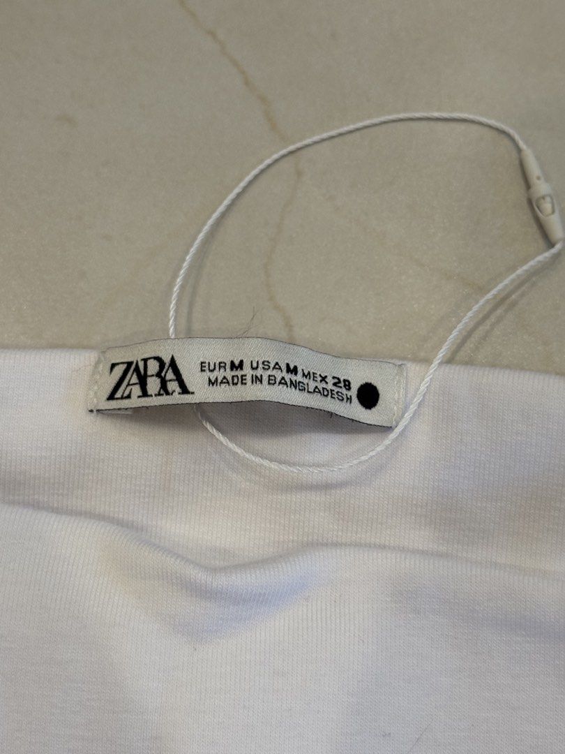 Zara White Tank Top - Size M (Category: Sleeveless) located in Quezon City. Submitted by closetarchives (Listing ID 1435787651, Image 2). Description: - Zara white tank top - Size: M - Features a square neckline - Thin straps - Made in Bangladesh - Versatile and easy to style.