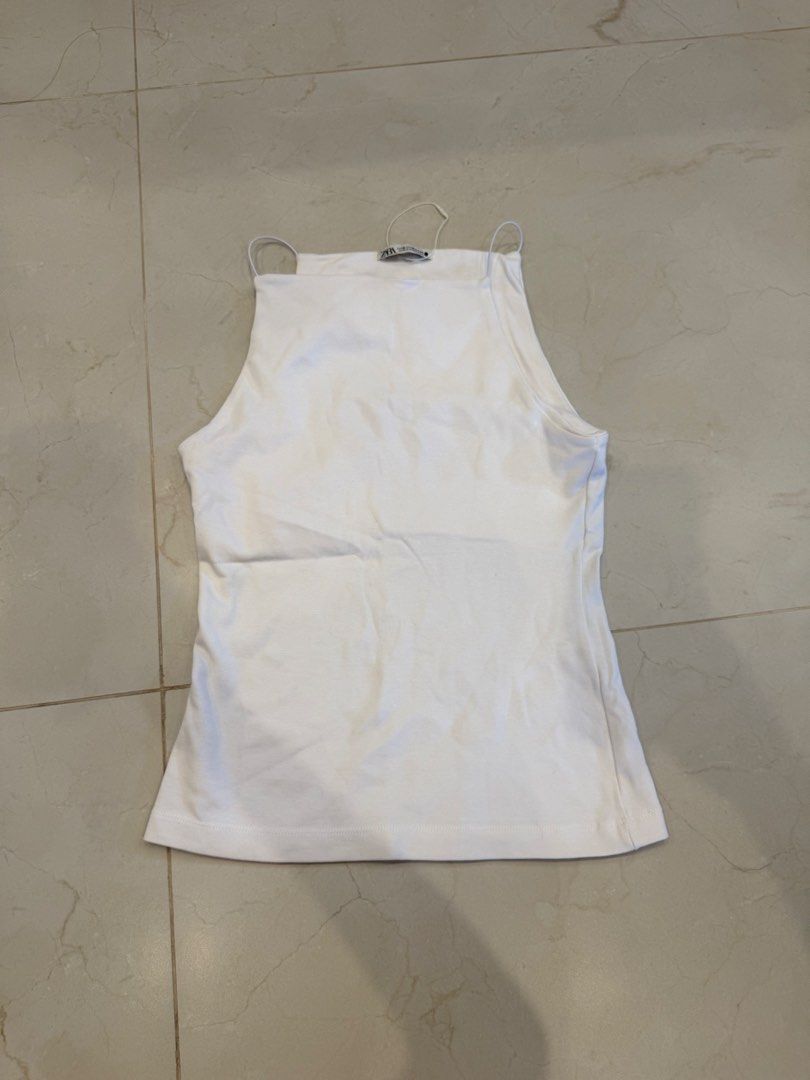 Zara White Tank Top - Size M (Category: Sleeveless) located in Quezon City. Submitted by closetarchives (Listing ID 1435787651, Image 1). Description: - Zara white tank top - Size: M - Features a square neckline - Thin straps - Made in Bangladesh - Versatile and easy to style.