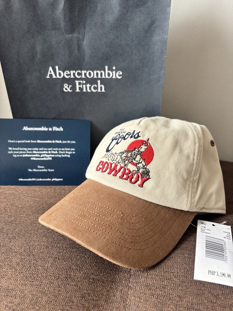 Abercrombie & Fitch x Coors Cap (Category: Caps & Hats) located in Quezon City. Submitted by authenkicks (Listing ID 1440809799, Image 1). Description: - Authentic Abercrombie & Fitch cap - Features iconic Coors cowboy design - Stylish two-tone: tan brim, beige crown - Adjustable strap for a custom fit - Ideal for everyday casual wear - Bought during A&F Philippines opening date - Authentic 💯 with receipt and paperbag - tags still intact NEGOOOO