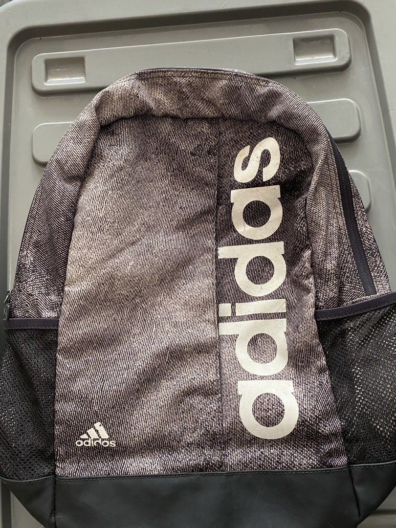 Adidas Backpack Grey Black White Logo (Category: Backpacks) located in Manila. Submitted by mpt99876 (Listing ID 1440865305, Image 2). Description: - Stylish Adidas backpack with a grey and black patterned design. - Features the iconic Adidas logo prominently on the front. - Convenient side mesh pockets for water bottles or essentials. - Adjustable straps for a comfortable, customized fit. - Perfect for school, work, or everyday adventures..