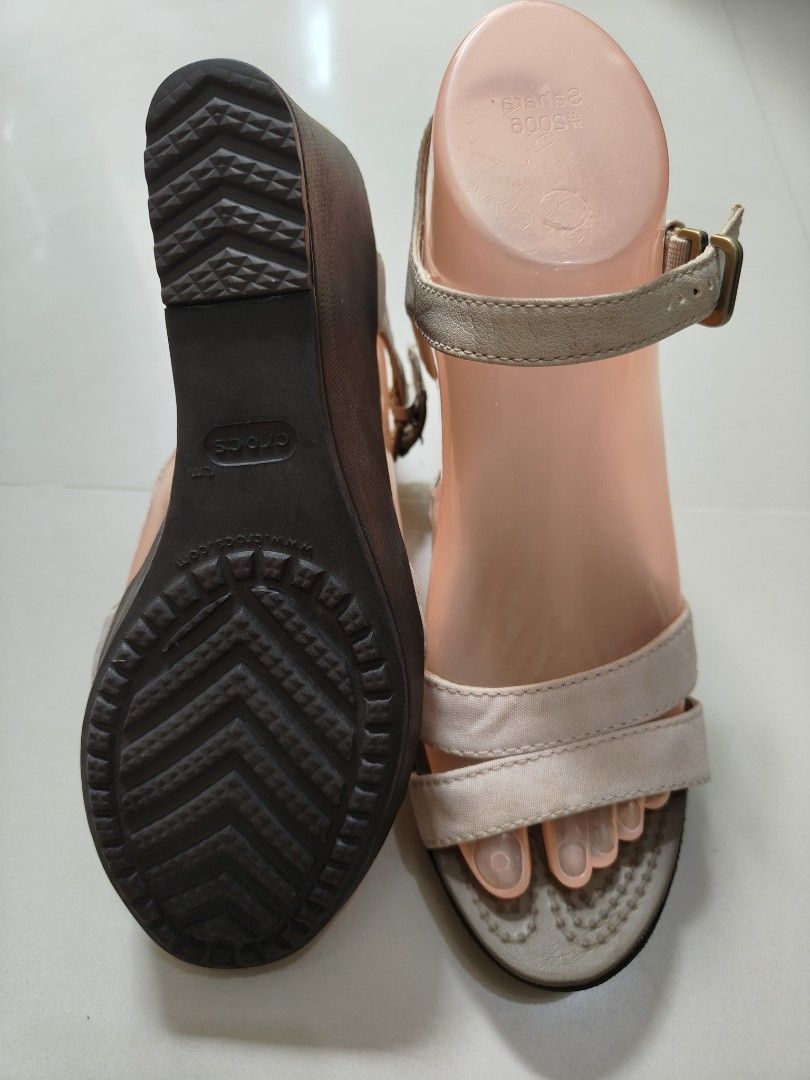 Authentic Crocs Wedge Sandals Beige Tan Buckle Straps - W7 (Category: Sandals) located in Calamba. Submitted by an_ne0501 (Listing ID 1440925603, Image 3). Description: - 24cm insole - Comfortable wedge sandals from Crocs - Beige and tan straps with adjustable buckle closure - Provides a bit of height with the wedge heel - Versatile for casual outings or dressing up an outfit - Features a sole with good grip - Stylish and practical footwear choic