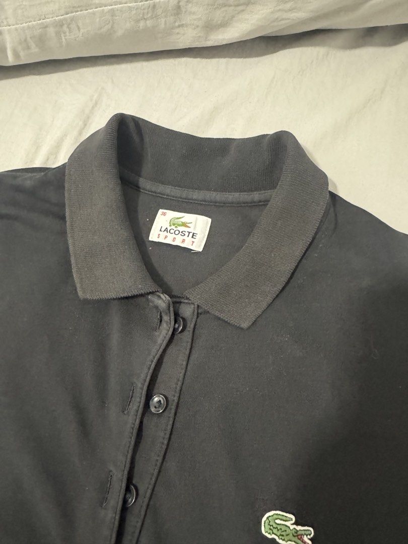 Authentic Lacoste Sport Black Polo Shirt (Category: Shirts) located in Imus. Submitted by oliviascents (Listing ID 1440888913, Image 2). Description: - Classic black Lacoste Sport polo shirt - Features iconic crocodile logo on chest - Button-up neckline with comfortable collar - Short sleeves - Ideal for casual wear or a sporty look W 15, L 25.