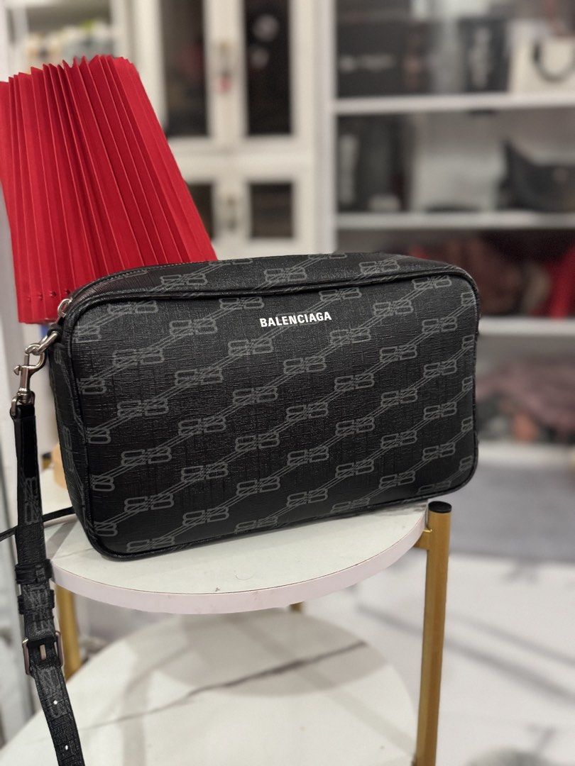 Balenciaga BB Monogram Camera Bag Black (Category: Luxury Bags & Wallets) located in Paranaque City. Submitted by shenarilyn (Listing ID 1440940567, Image 2). Description: - Authentic Balenciaga Camera Bag - Features iconic BB Monogram print - Color: Black with grey pattern - Accented with sleek silver hardware - Comes with original dust bag and shopping bag with receipt - Ideal for everyday style and convenience.