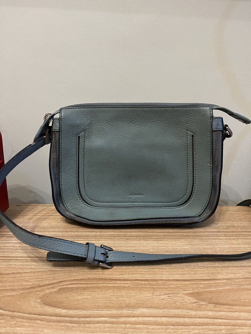 BEANPOLE Leather Crossbody Bag Light Blue (Category: Cross-body Bags) located in Quezon City. Submitted by metamerchant (Listing ID 1440917911, Image 1). Description: - Light blue BEAMPOLLE crossbody bag - Textured leather finish - Zipper closure (sides and top) - Adjustable strap with buckle - size: 9inches x 7.5inches - needs cleaning.