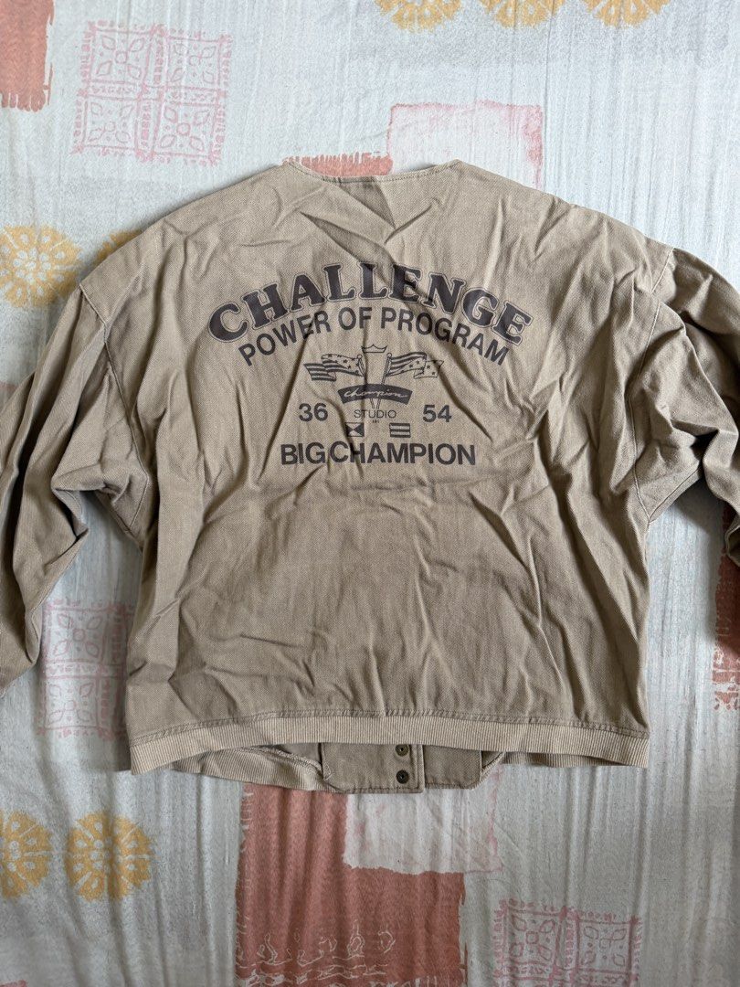 Beige Button-Up Jacket with 'Challenge' Graphic Back (Category: Coats, Jackets and Outerwear) located in Manila. Submitted by chiechums (Listing ID 1440793892, Image 2). Description: - Cool beige jacket - Round neckline - Button-up front - Two front pockets - Long sleeves with elasticated cuffs - Bold 'CHALLENGE POWER OF PROGRAM' graphic on the back - Ideal for casual and streetwear outfits - Easy to style.
