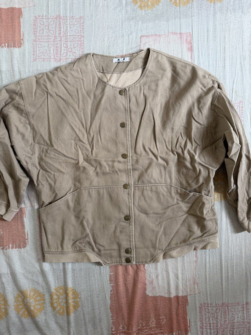 Beige Button-Up Jacket with 'Challenge' Graphic Back (Category: Coats, Jackets and Outerwear) located in Manila. Submitted by chiechums (Listing ID 1440793892, Image 1). Description: - Cool beige jacket - Round neckline - Button-up front - Two front pockets - Long sleeves with elasticated cuffs - Bold 'CHALLENGE POWER OF PROGRAM' graphic on the back - Ideal for casual and streetwear outfits - Easy to style.