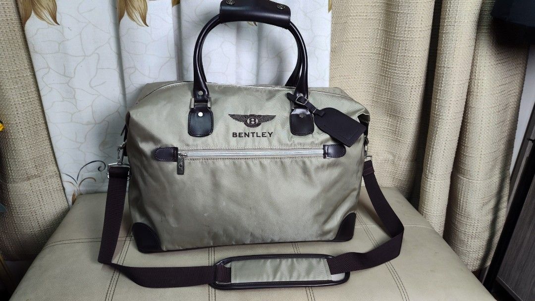 Bentley Duffle Bag Travel Weekender Bag (Category: Luxury Bags & Wallets) located in Quezon City. Submitted by edwinvuru (Listing ID 1440860613, Image 2). Description: - Bentley duffle bag - Ideal for weekend trips or carry-on luggage - Includes top handles and a detachable shoulder strap - Made with durable material - Ample interior space - Zippers feature the Bentley logo - Accented with dark brown leather.
