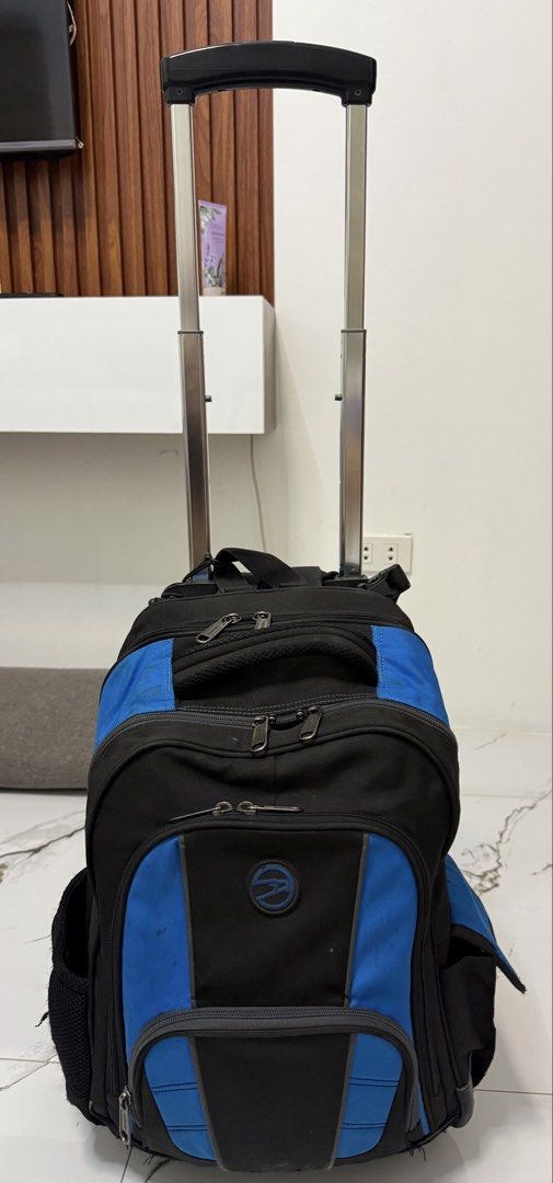 Black and Blue Rolling Backpack with Telescopic Handle (Category: Backpacks) located in Quezon City. Submitted by lucialove (Listing ID 1440917243, Image 1). Description: - Hawk 5595 Large Backpack Stroller With Virupro Anti-Microbial Protection Black and blue rolling backpack - Telescopic handle for easy transport - Multiple zippered compartments for organization - Side mesh pockets - Minor scuffs and a small tear on one mesh pocket - Still full