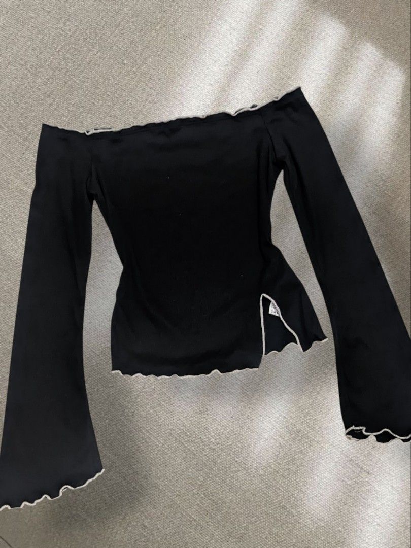 Black Off-Shoulder Top with Bell Sleeves (Category: Blouses) located in Pili. Submitted by shobiiifinds_26 (Listing ID 1440777368, Image 1). Description: - Black off-shoulder top - Long, flowy bell sleeves - Lettuce hem detail on neckline, cuffs, and hem - Small side slits - Versatile for night outs or casual wear.