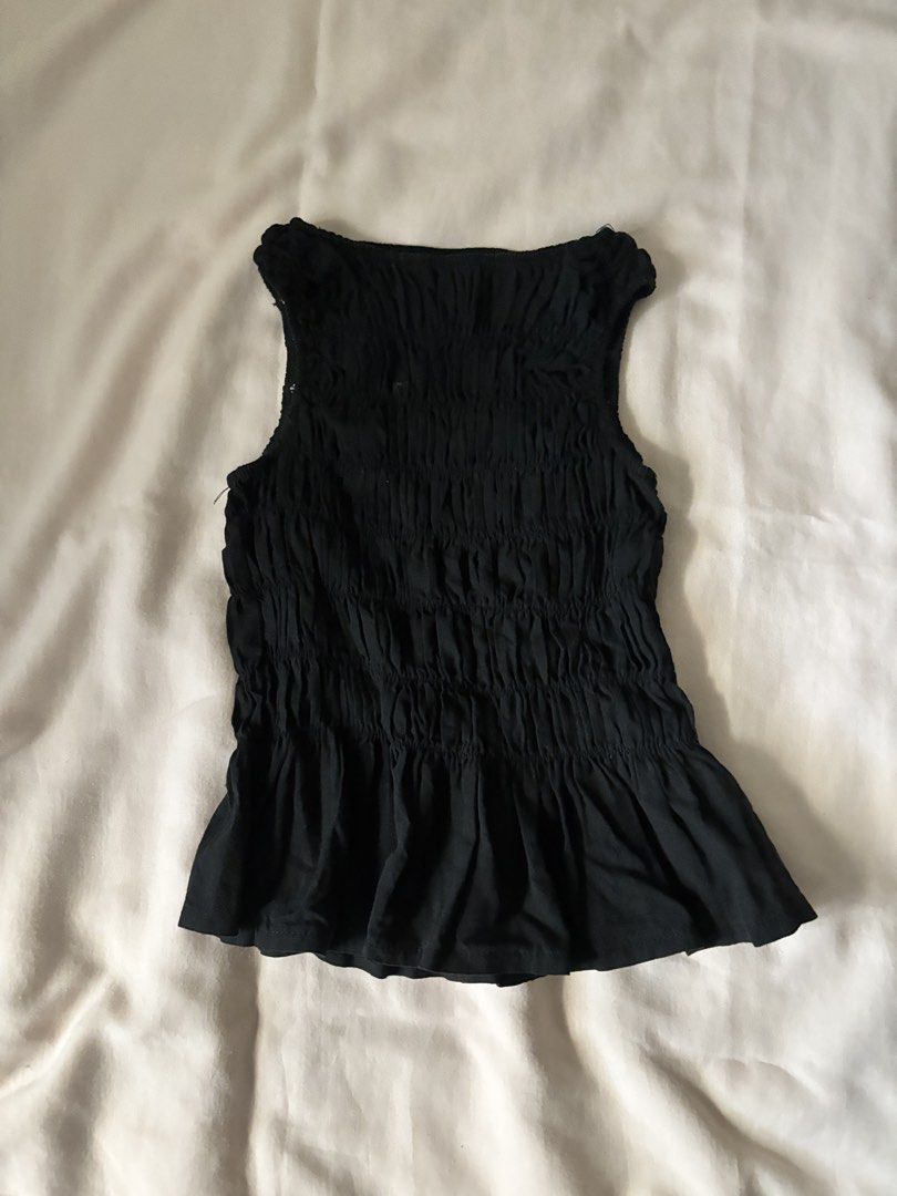 Black Ruched Sleeveless Peplum Top (Category: Sleeveless) located in Pasig City. Submitted by r_ain (Listing ID 1440860566, Image 1). Description: - Black sleeveless top - All-over ruched detailing - Used once only! - Fits best on S to M.