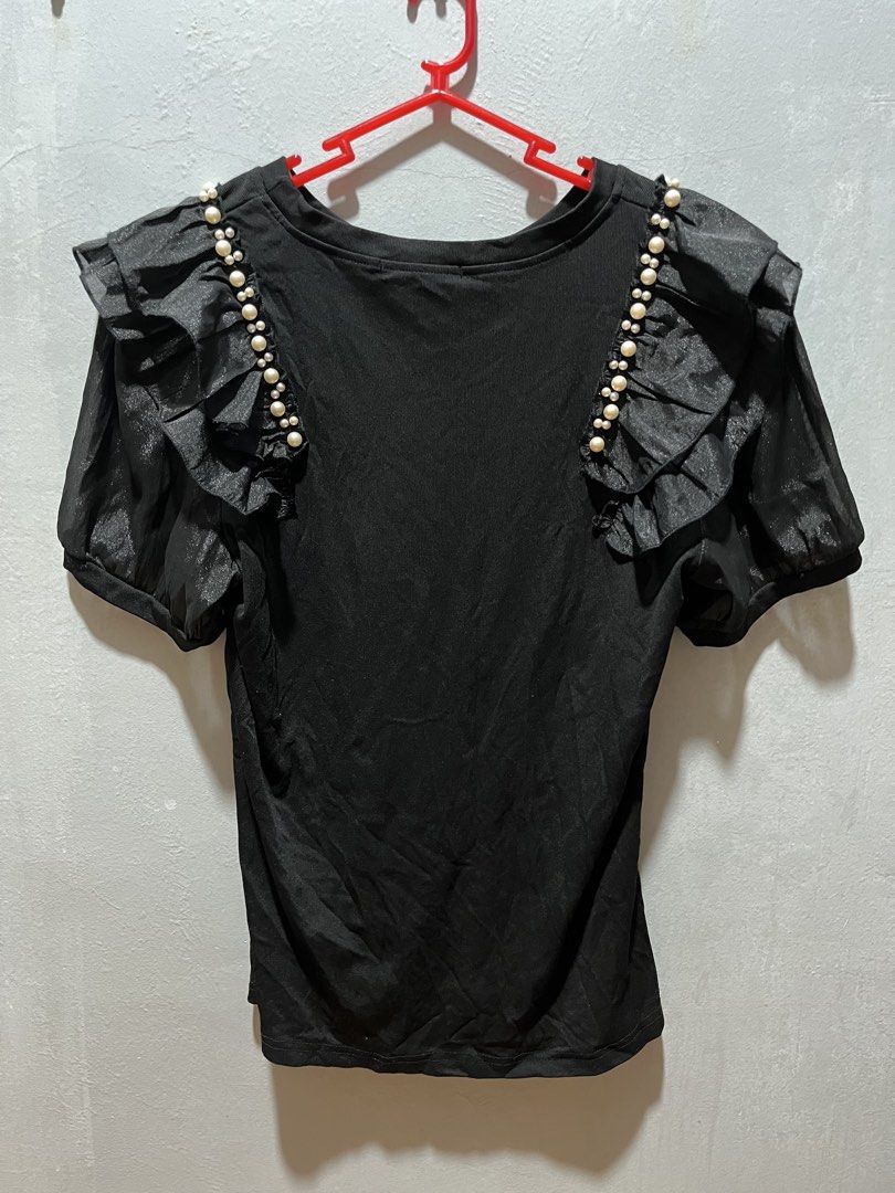 Black Top with Pearl and Ruffle Sleeves (Category: Blouses) located in Taguig. Submitted by ls_ln (Listing ID 1440783218, Image 1). Description: - Chic black top with short puff sleeves. - Ruffled shoulder details embellished with pearls. - Sleeves have a subtle sheen. - Size: L - Ideal for evening wear or special occasions..