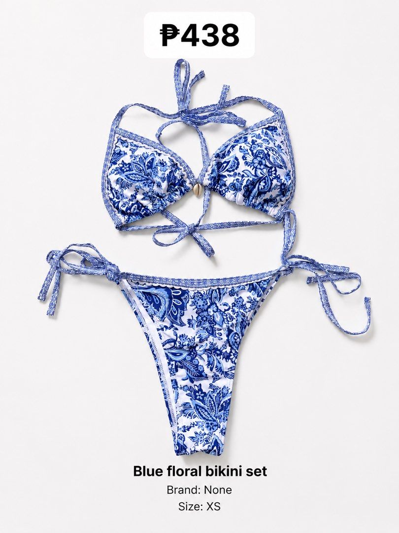 Blue Floral Bikini Set with Shell Detail (Category: Bikinis & Swimsuits) located in Quezon City. Submitted by poshforward (Listing ID 1440850706, Image 2). Description: - Adorable blue and white floral print bikini set. - Halter neck top with adjustable tie closures. - Matching bottoms with adjustable tie sides. - Features a charming shell detail at the center of the top. - Made from a comfortable polyester and elastane blend. - Care instructions