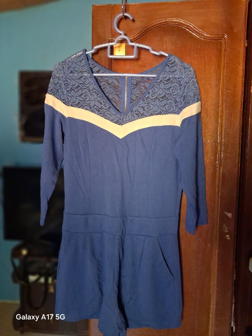 Blue Lace Detail V-Neck Romper (Category: Rompers) located in Caloocan City. Submitted by qymechi_02 (Listing ID 1440801061, Image 1). Description: - Delicate lace detailing on the V-neckline - Light beige trim accents the lace - Long sleeves - Zipper closure at the back - Subtle pleating on the front for a flattering fit - Ideal for a night out or a special occasion.