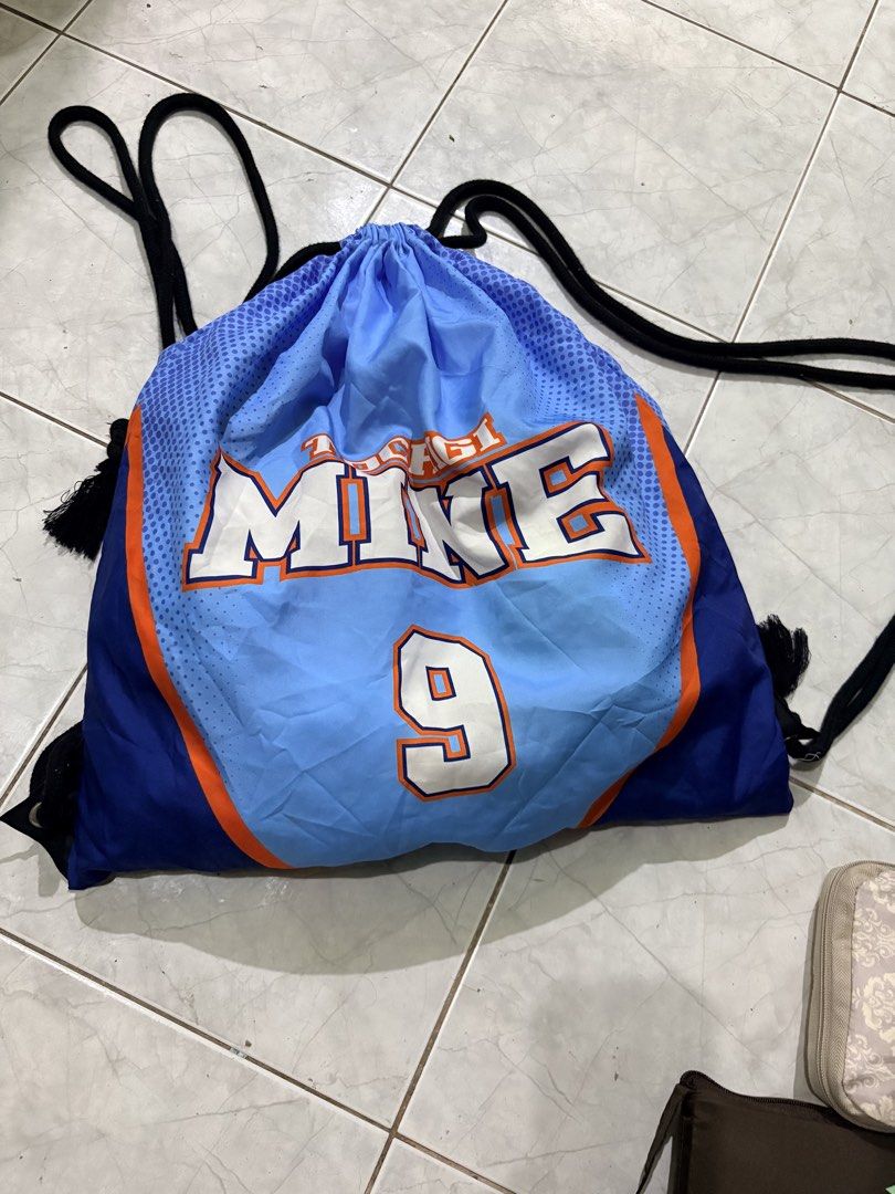 Blue Nike Drawstring Bag with Number 9 (Category: Backpacks) located in Paete. Submitted by skydruemadison (Listing ID 1440894648, Image 1). Description: - Cool blue Nike drawstring bag - Features 'MIKE' and the number 9 - Ideal for gym sessions or everyday carry - Black drawstrings with tassels - Shows some signs of wear, but still in good usable condition.