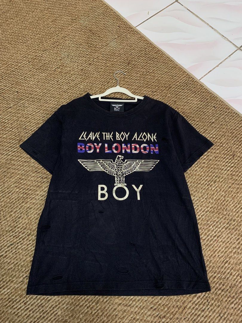BOY LONDON Black Eagle Graphic T-Shirt (Category: Tshirts & Polo Shirts ) located in Taguig. Submitted by eloire (Listing ID 1440895204, Image 1). Description: NO LP!!! MESSAGE ME FIRST BEFORE OFFERING FOR CONFIRMATION!❗️ -Dimes: 22 x 26 (M-L) - Authentic BOY LONDON black t-shirt - Features iconic eagle graphic - "LEAVE THE BOY ALONE" text detail - Distressed details on hem and sleeves for a worn-in look - Tag clearly shows "BOY LONDON" branding.