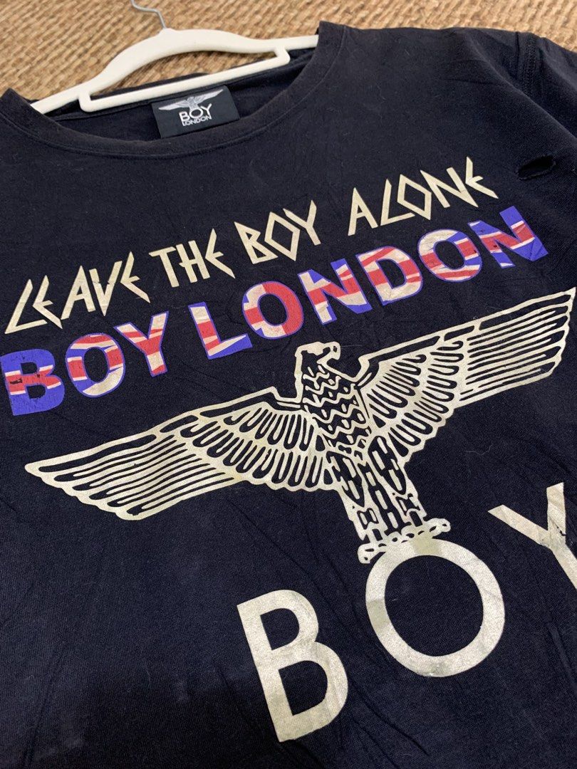 BOY LONDON Black Eagle Graphic T-Shirt (Category: Tshirts & Polo Shirts ) located in Taguig. Submitted by eloire (Listing ID 1440895204, Image 2). Description: NO LP!!! MESSAGE ME FIRST BEFORE OFFERING FOR CONFIRMATION!❗️ -Dimes: 22 x 26 (M-L) - Authentic BOY LONDON black t-shirt - Features iconic eagle graphic - "LEAVE THE BOY ALONE" text detail - Distressed details on hem and sleeves for a worn-in look - Tag clearly shows "BOY LONDON" branding.