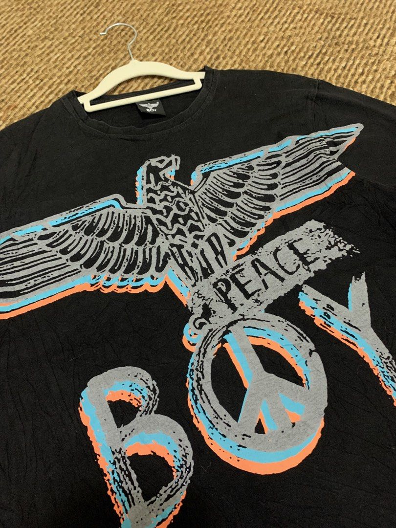 BOY London Eagle Peace T-Shirt Black (Category: Tshirts & Polo Shirts ) located in Taguig. Submitted by eloire (Listing ID 1440895201, Image 3). Description: NO LP!!! MESSAGE ME FIRST BEFORE OFFERING FOR CONFIRMATION!❗️ - Dimes: 20 x 27 - Authentic BOY London t-shirt - Features iconic eagle graphic - 'BOY' and 'PEACE' text prominently displayed - Large peace sign graphic - Vertical stripe and smaller BOY London logo on the back - Perfect statemen