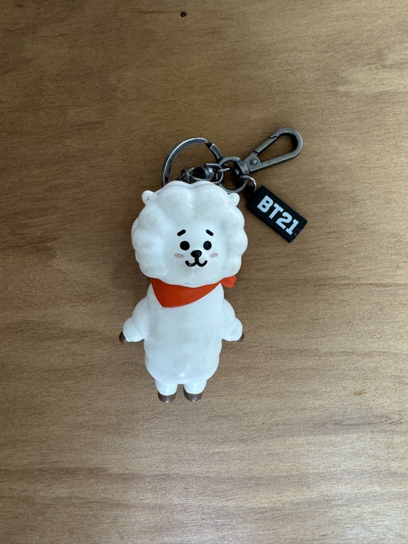 BT21 RJ Character Keychain with Orange Scarf (Category: Character Goods) located in Silang. Submitted by xoxovintage98 (Listing ID 1440780997, Image 1). Description: - With tags - Cute RJ keychain from BT21 - Features RJ with signature orange scarf - Includes a metal clasp - Small black tag with 'BT21' logo - Ideal for decorating bags, backpacks, or as a gift for BTS fans.