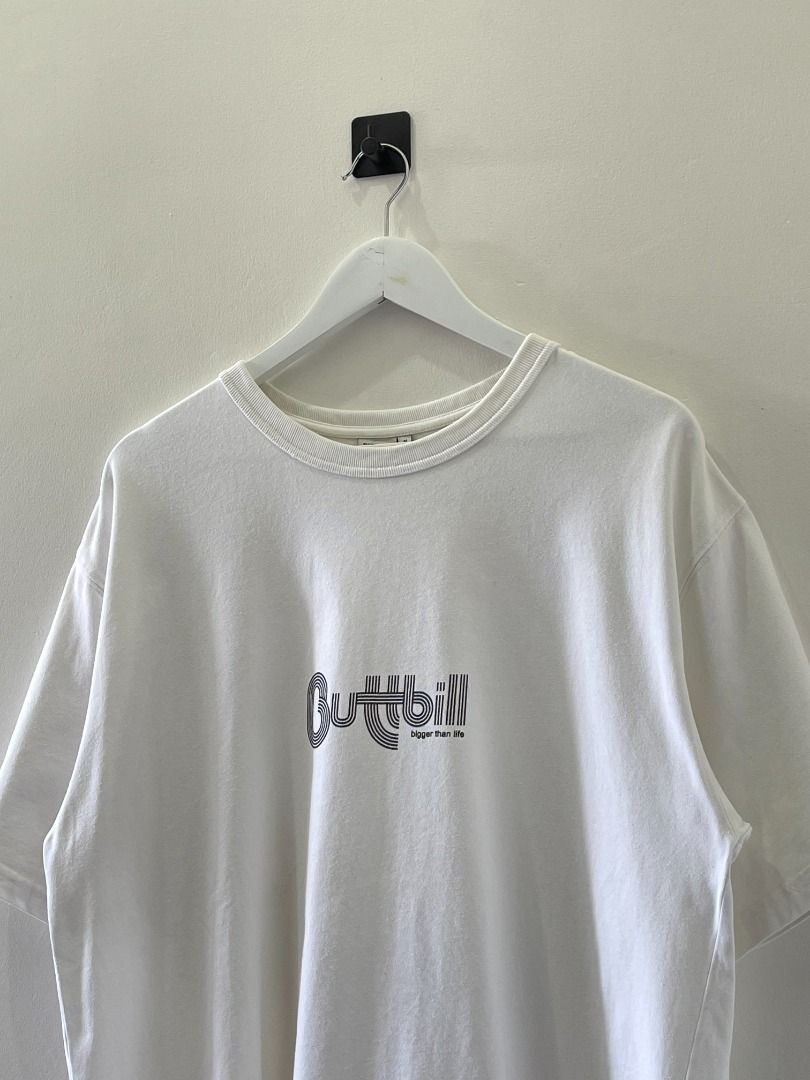 Buttbill Bigher Than Life tee shirt (Category: Tshirts & Polo Shirts ) located in Abucay. Submitted by argarments.ph (Listing ID 1440927972, Image 1). Description: White Buttbill tee. Features the 'Higher Than Life' graphic on the front. Small woven tag on the side seam. Simple, classic fit. Good for everyday wear. Tagged: Medium on tag, fits Large Width 22.5" | Length 29.5" Condition: Great Issue(s): Small dirt stain.