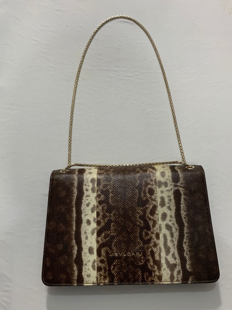 Bvlgari Serpenti Forever shoulder bag (Category: Luxury Bags & Wallets) located in Quezon City. Submitted by mamaloveaminah (Listing ID 1440883321, Image 2). Description: - Authentic Bvlgari Serpenti Forever shoulder bag crafted from brown snake print karung leather with a snake head motif clasp. - Serial Number: FP.N12.35576 - Holographic authenticity sticker - Interior: Pink fabric - Exterior: Beige/Gold tone - Closure: Zipper.